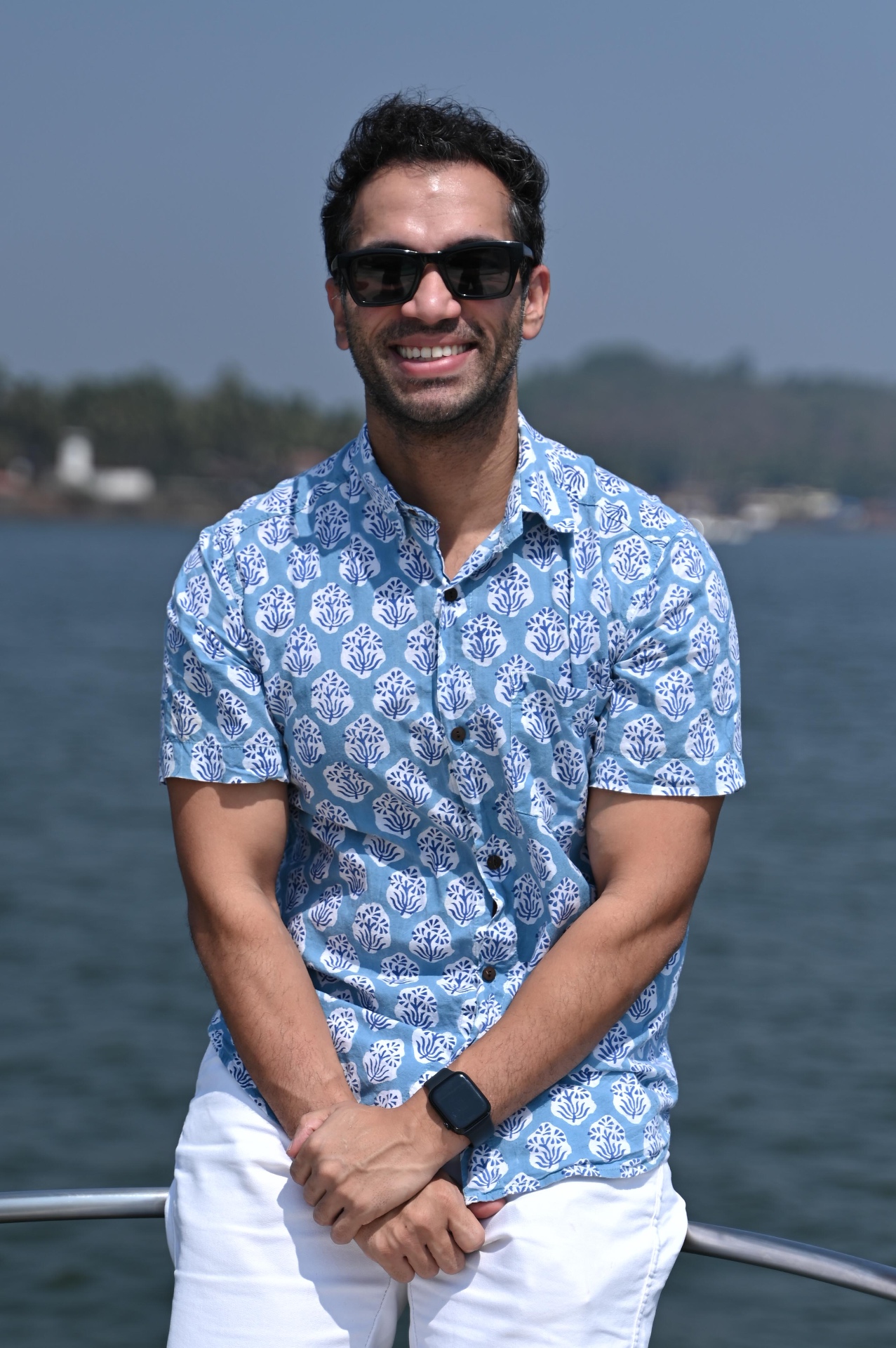 Founder of RareRoute, smiling outdoors by the water